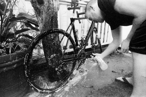 Zach washing his bike in the backyard.