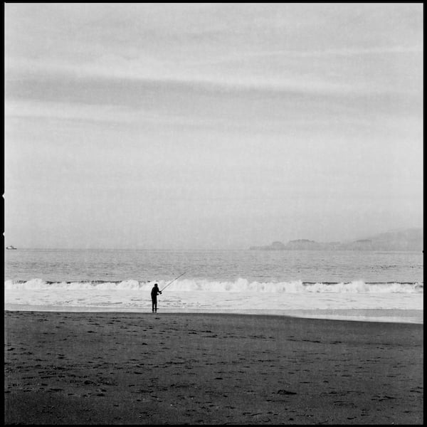 Man fishing at Baker Beach