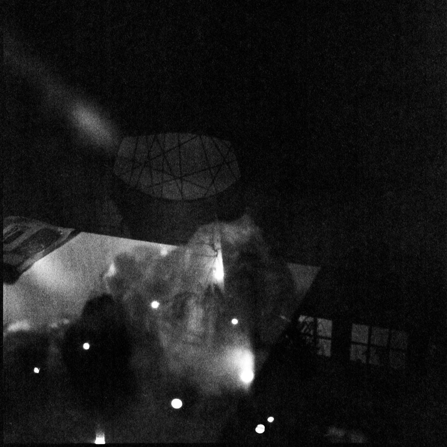 Looking out a window at night with reflections of interior on glass