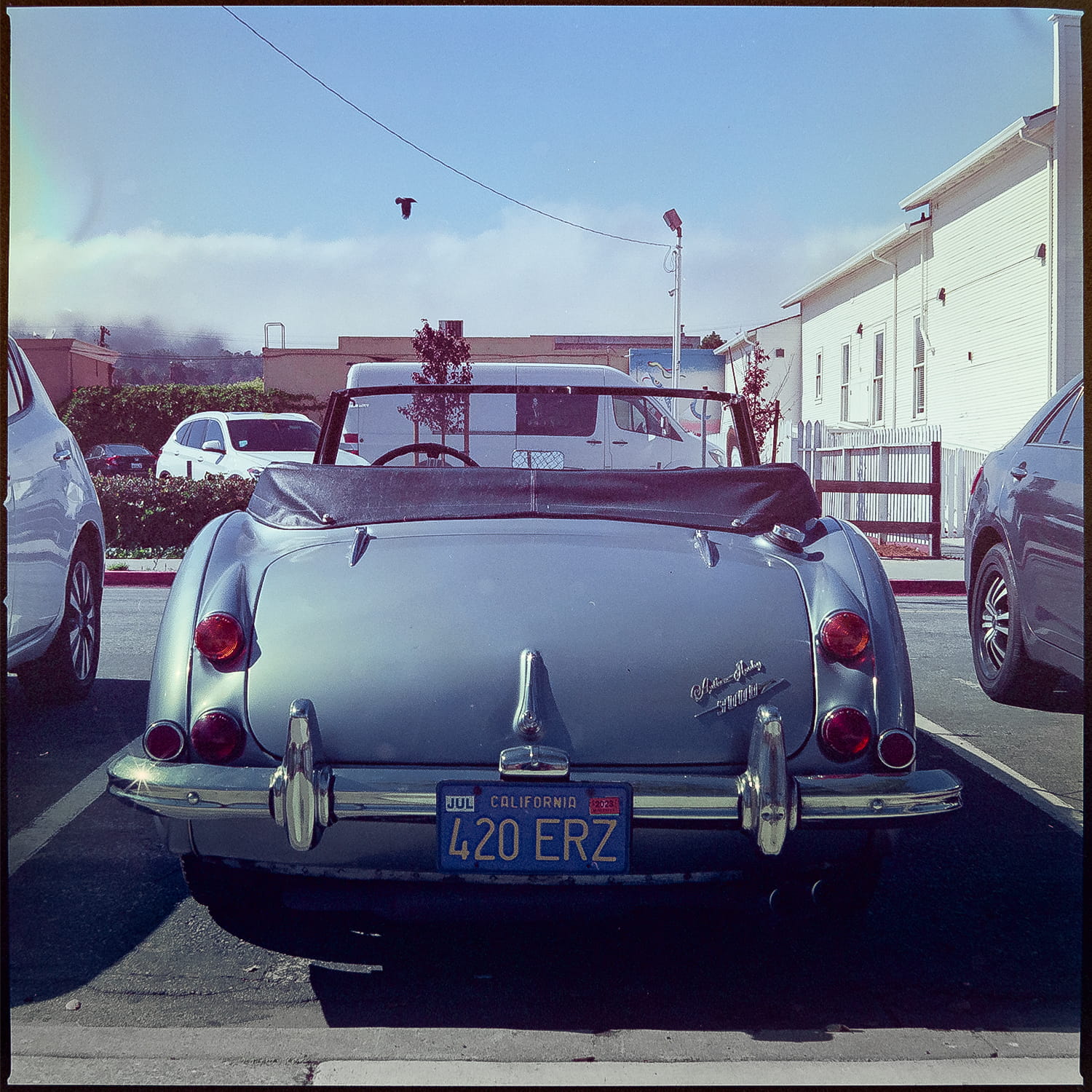 An old car with four twenty in the license plate