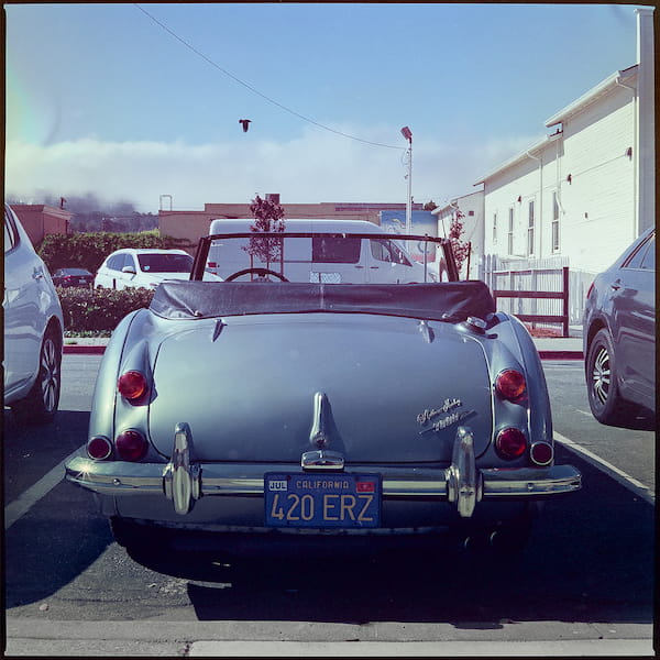 An old car with four twenty in the license plate