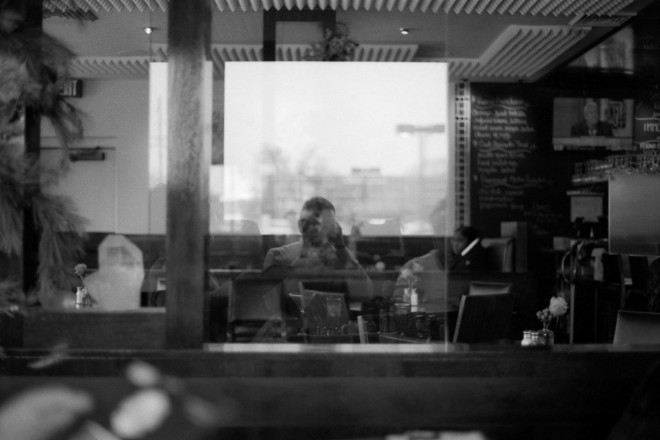 Self portrait in a glass reflection in a restaurant